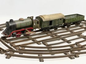 A 1930’s Marklin R900 clockwork locomotive train set, including 2 carriages and tracks. Made in