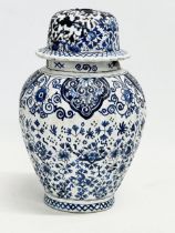 A late 19th/early 20th century Dutch Delft Earthenware jar with lid. Signed. 24cm