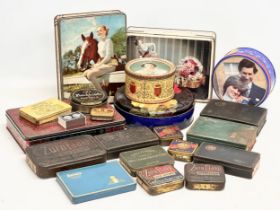 A collection of vintage tobacco and biscuit tins.