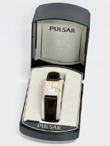 A Pulsar watch with case.