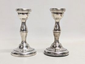 A pair of silver candlesticks. 10.5cm