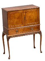 A 1950’s Georgian style Burr Walnut cocktail cabinet with Queen Anne legs. 80x39x103cm