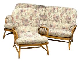 A 2 piece Ercol ‘Jubilee’ Mid Century elm suite. 3 seater and an armchair.