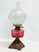 A late Victorian brass oil lamp with Ruby Glass bowl. 55cm