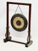 A late 19th/early 20th century Chinese brass gong in a later rosewood frame. 46x21x68cm