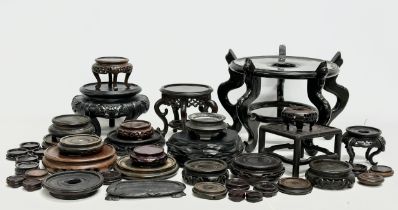 A large quantity of 19th and early 20th century Chinese/Japanese wooden stands. Largest 35x23cm.