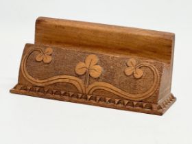 A desktop rack with Irish clover motif. Written ‘Reg Major Made This’ 16.5x7cm