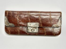 A late 19th century crocodile leather purse with silver mounts. Stamped HM silversmiths. 14cm