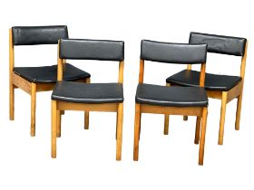 A set of 4 Mid Century dining chairs with black vinyl seats and backs. Stamped crows feet