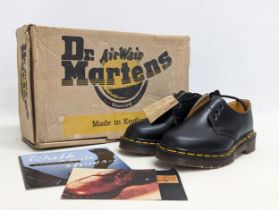 A pair of Dr Martens in original box. Size UK 1. Style B-SM1461Z. Black Smooth 3 Eyelet Shoe,