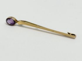 A 9ct and amethyst brooch. 2.24 grams. 6cm