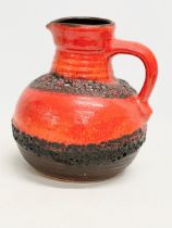 A Mid Century West German lava pot with handle. 18x21cm