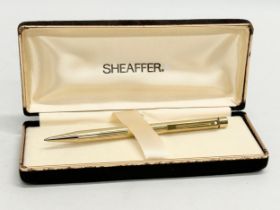 A gold electroplated Sheaffer pen with case.