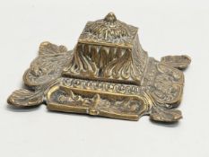 An early 20th century ornate brass inkwell with liner. 16x16x8cm