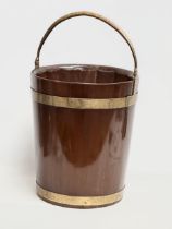 A George III mahogany brass bound peat bucket with brass handle. Circa 1790. 38x37x46cm not