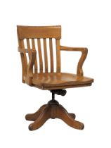An Edwardian oak swivel desk chair.