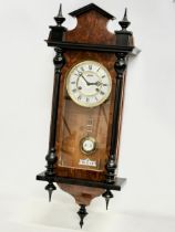 A good quality Victorian style Burr Walnut and mahogany Vienna wall clock by Astra. With pendulum