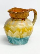 A 1930’s English Art Deco glazed pottery jug. 18x21x19cm
