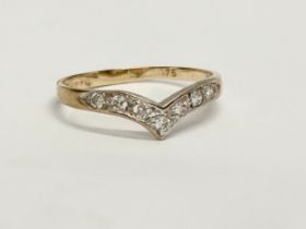 A vintage 9ct gold and diamond wish bone ring with case. Size O. 1.25 grams.