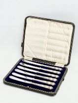 A set of 6 early 20th century silver handled butter knives with case, by John Biggin. 1908.