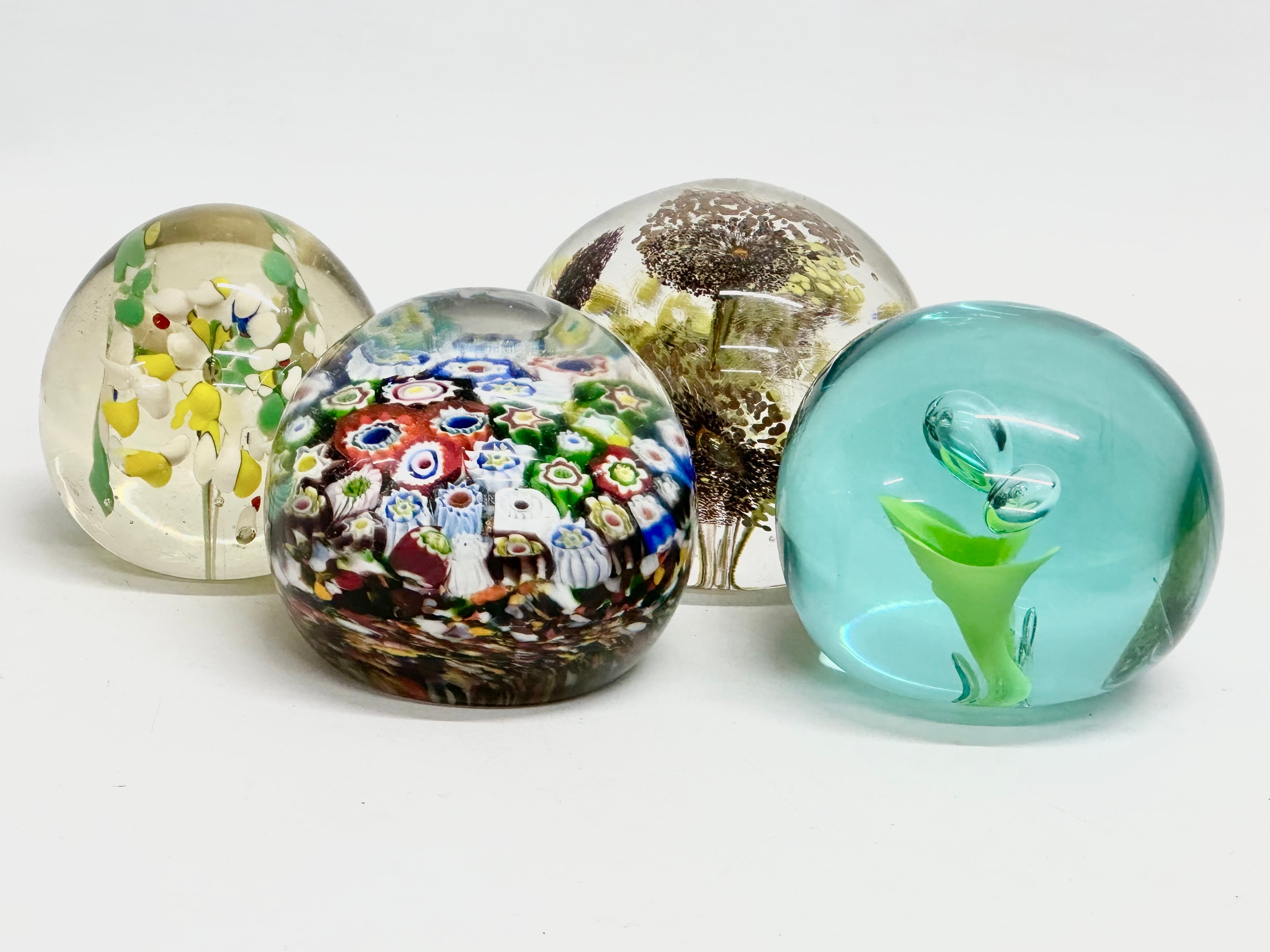 A late 19th/early 20th century glass dump paperweight and 3 others. A vintage millefiori paperweight