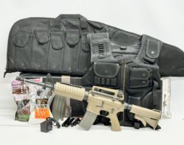 An Umarex Elite Force electric assault rifle with box, pellets, tactical vest, carting case etc.