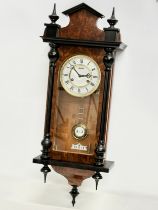 A good quality Victorian style Burr Walnut and mahogany Vienna wall clock by Astra. With pendulum