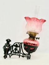 A Victorian wall bracket oil lamp with Ruby Glass bowl and shade. 34x50cm