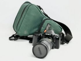 A Minolta Dynax 2xi camera with a Sigma Zoom AF lens.