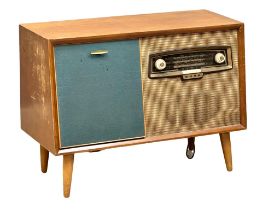 A Mid Century teak Bush radiogram with Gerrard turntable. 84x38x62cm