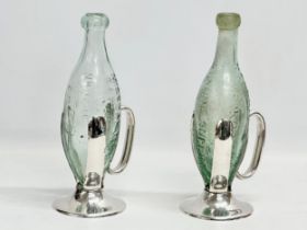 A pair of 19th century Roberts & Belk silver plated ‘Torpedo’ bottle holders with bottles. Including