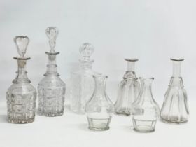 A collection of early and mid 20th century decanters. A pair of tall early 20th century Georgian