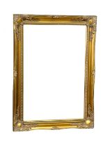 An ornate gilt framed bevelled mirror. 65x91cm