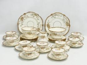 A 34 piece late 19th/early 20th century gilt and wild flower tea service. Circa 1900.