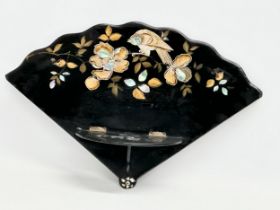 A late 19th century Japanese lacquered wall bracket with Mother of Pearl and hand painted gilding.