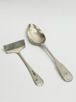 A Scottish Queen Elizabeth II silver teaspoon and a silver pusher, sheffield. 30.55 grams total.