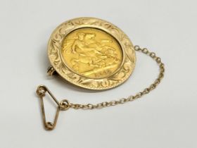 A gold half sovereign brooch. 6.7 grams.