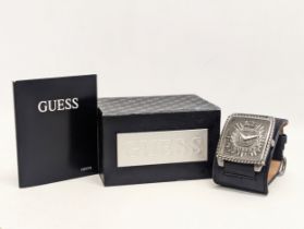 A gents Guess watch with leather strap and original box.