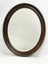 An Edwardian ornate framed bevelled mirror. 49x59cm