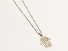 A silver hamsa pendant and necklace. 3.1g