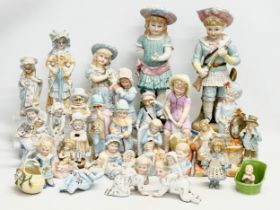 A large collection of late 19th and early 20th century German Bisque figurines. Largest pair 43cm.