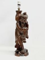 A large early 20th century Chinese carved fisherman figure lamp. 59cm