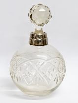 An early 20th century silver mounted perfume bottle. London mark. Faded makers mark. 15cm