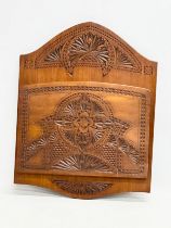 A large late 19th/early 20th century chip carved birch wall hanging paper rack. Circa 1900. 34x44cm