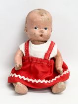 An early 20th century doll. 26cm