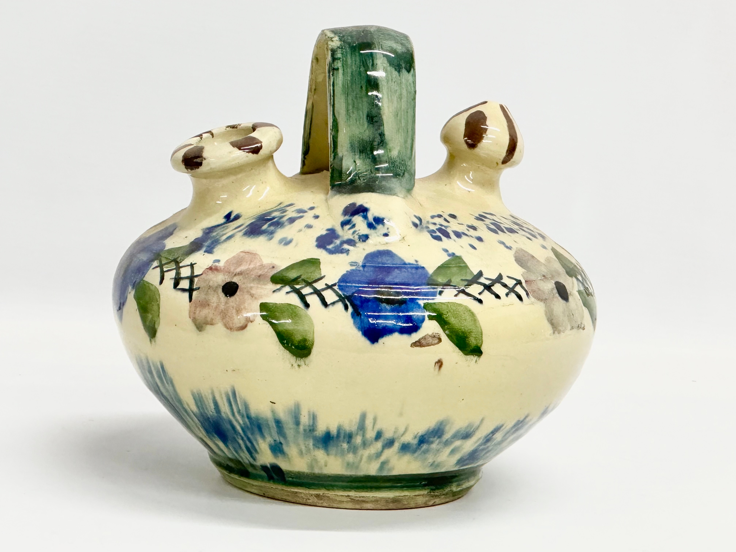 An early 20th century French glazed earthenware Gargoulette jug/wine jug. 20x20x20cm