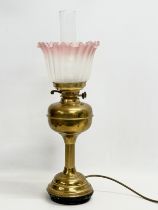 A large early 20th century brass electrified oil lamp with glass shade. 61cm