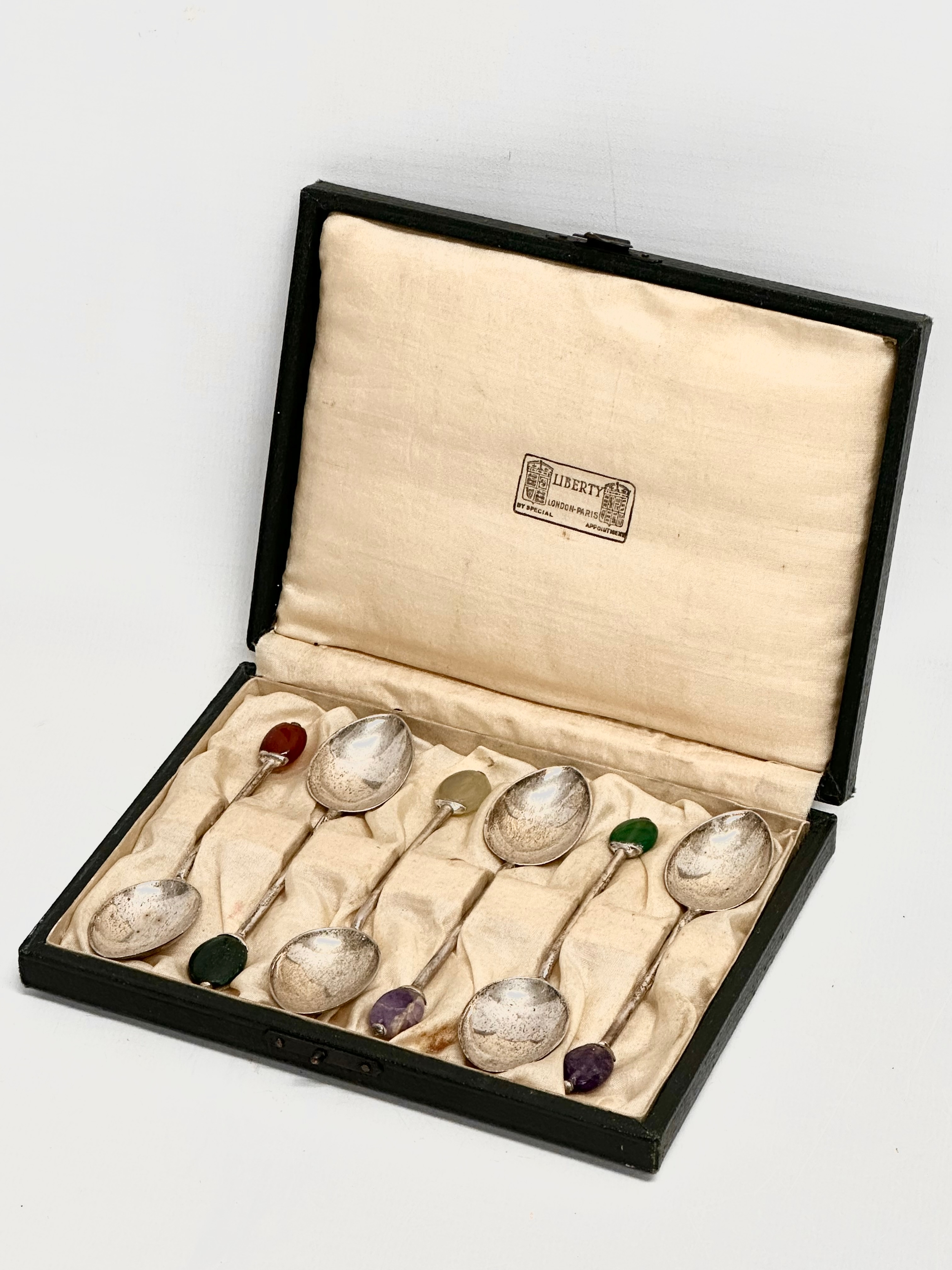 A set of 6 1920s Liberty & Co silver cocktail spoons with stone set handles in original case.