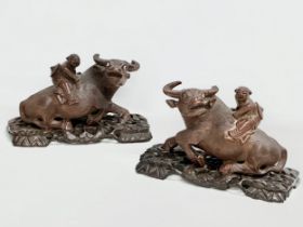 A pair of early 20th century Chinese carved Water Buffalo’s with riders on stands. 26x12x16cm