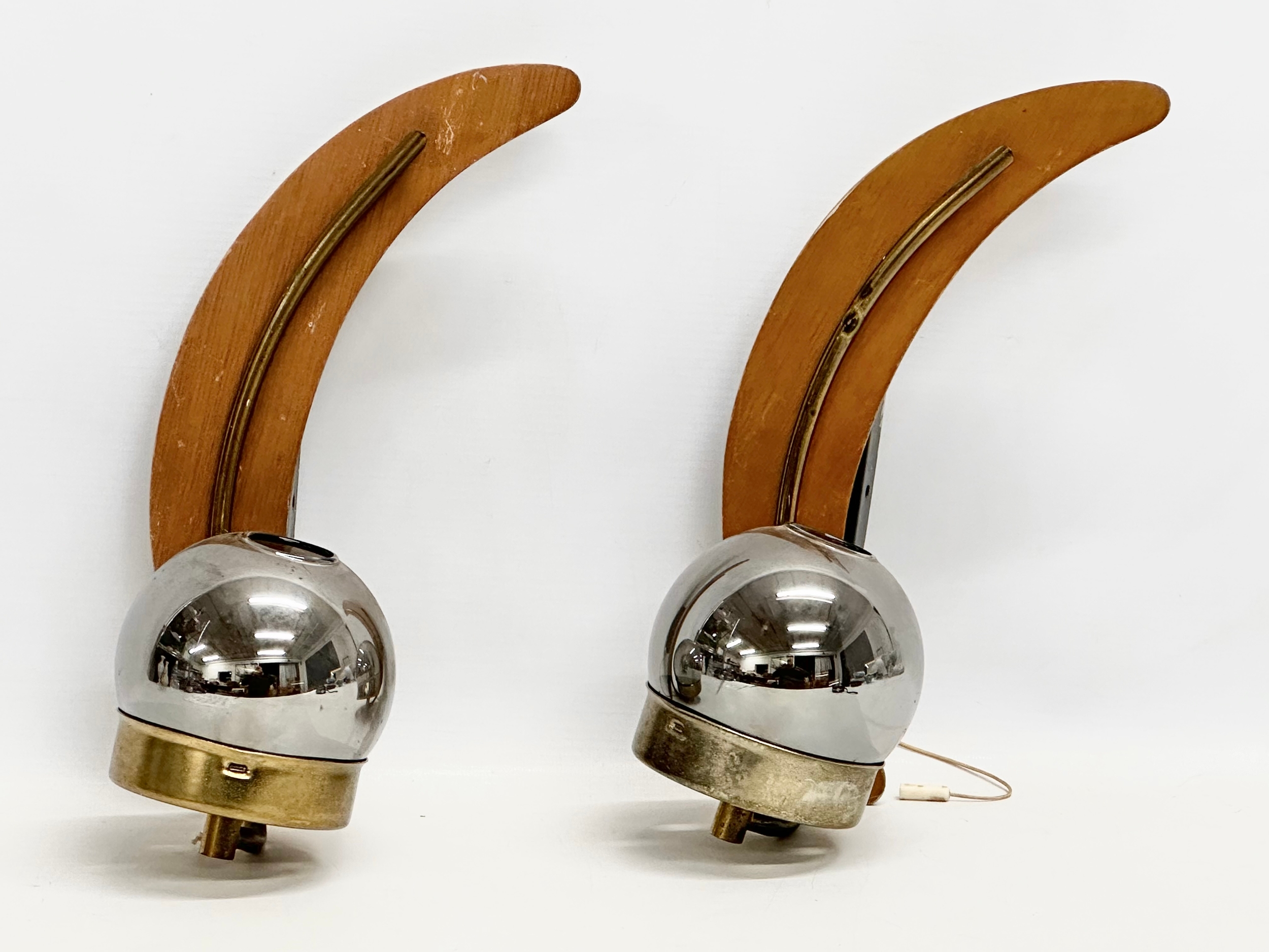 A pair of 1960’s Mid Century teak and brass wall lights with glass shades. 31cm